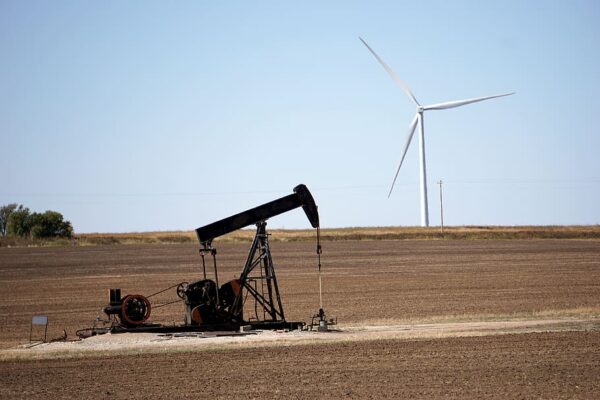 Oil rig and wind turbine tower in same scene